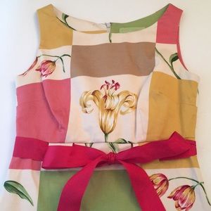 Summer dress with ribbon tied at waist.